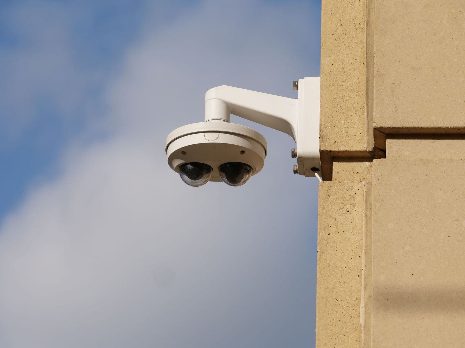 Dome security camera mounted on a building wall