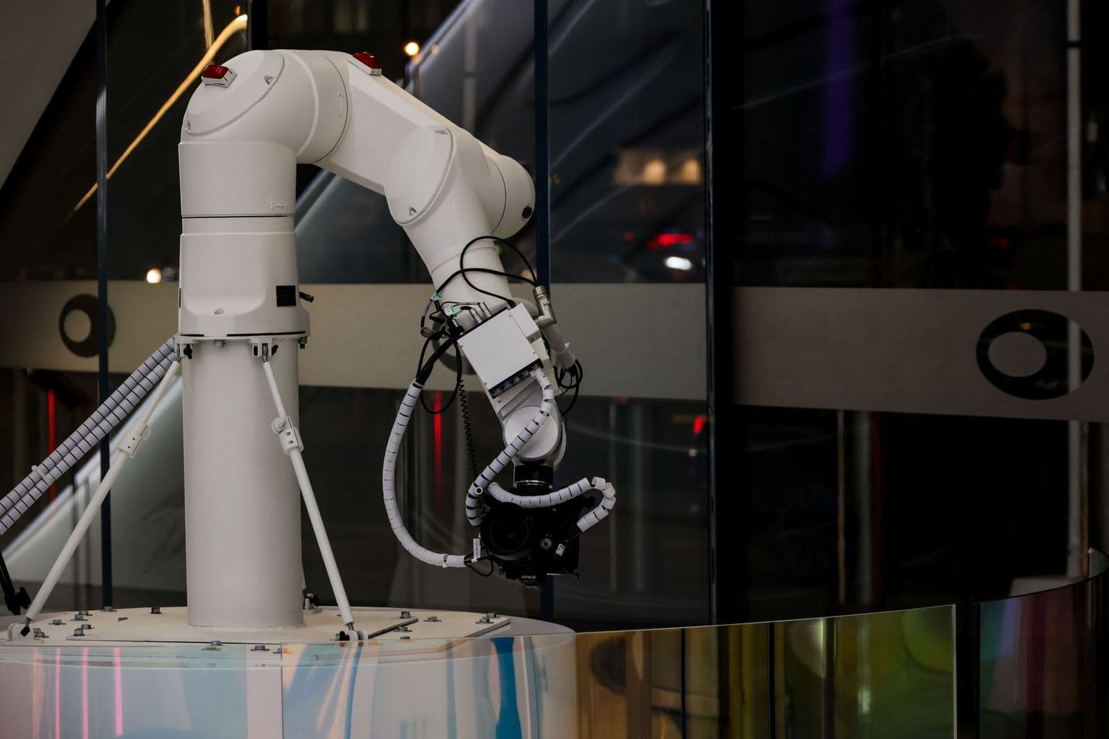 White robotic arm working inside an automated cell